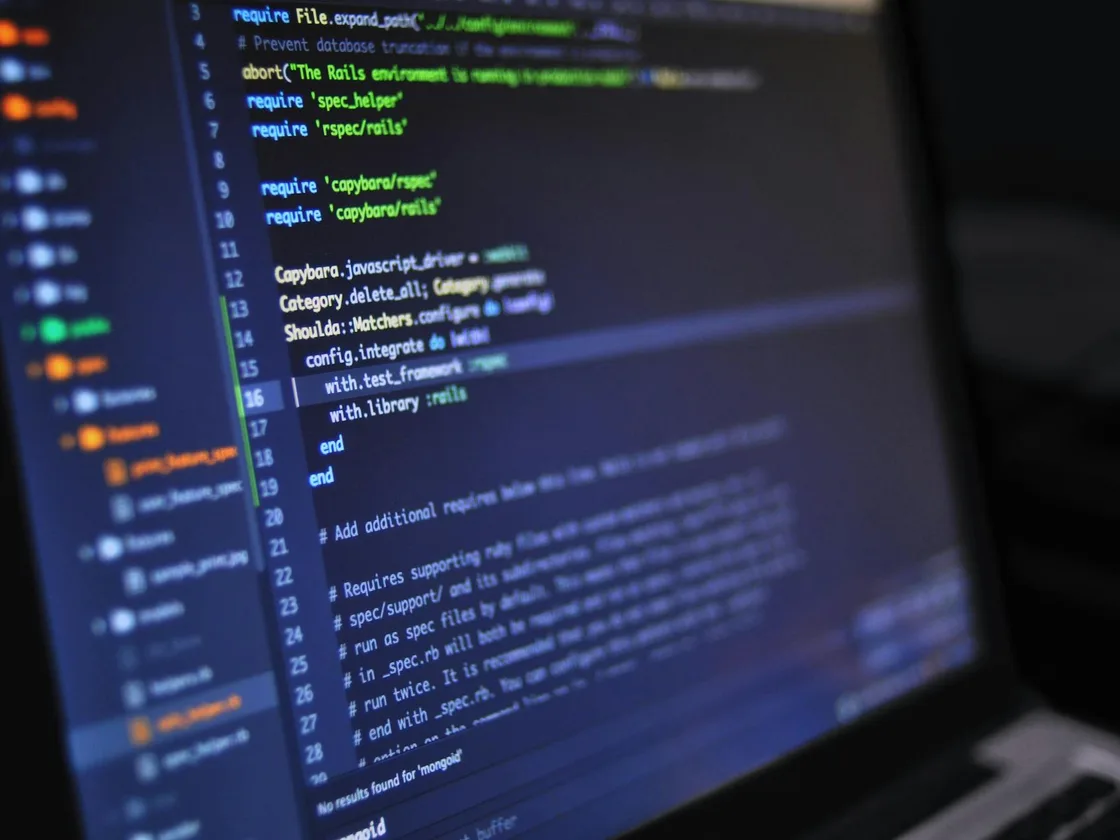 Developer working on code at dual monitors
